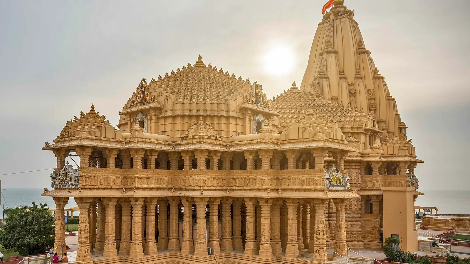 Somnath Jyotirlinga temple at dusk, seen from the Arabian Sea shore